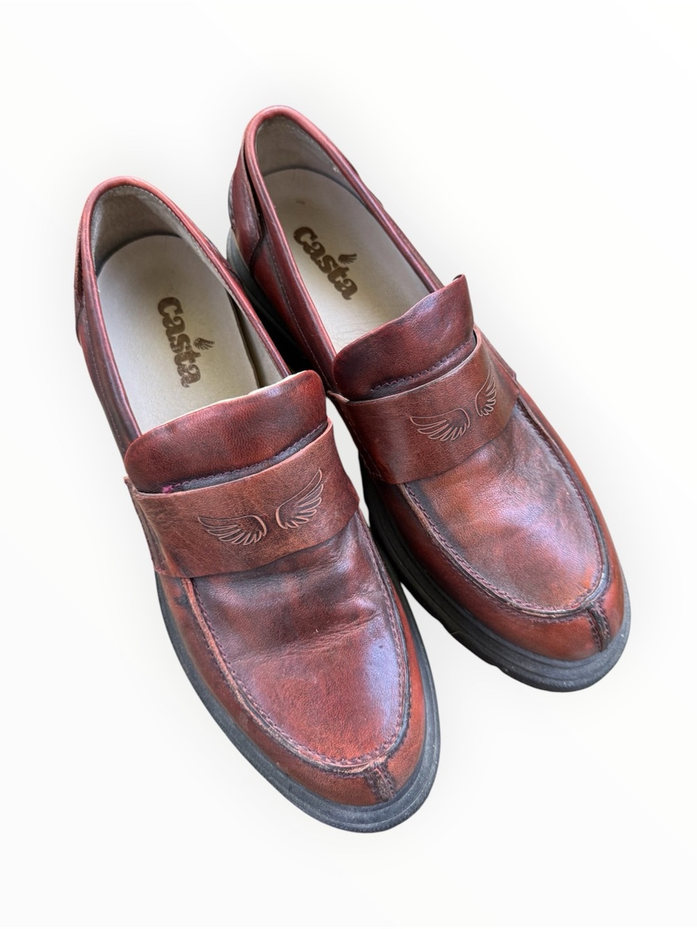 Casta branded loafers featuring a brown leather upper and a chunky platform sole